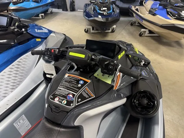Slide: The Image of A 2026 Sea-Doo RXT-X jet ski is displayed in a showroom alongside other watercraft. - 12