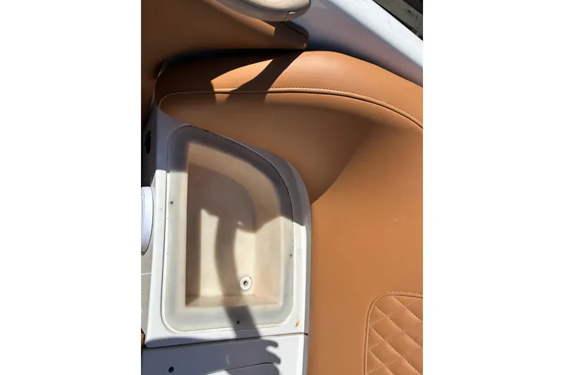 Slide: The Image of 2000 MasterCraft MariStar 210 VRS boat interior with tan leather seating and storage compartment. - 21
