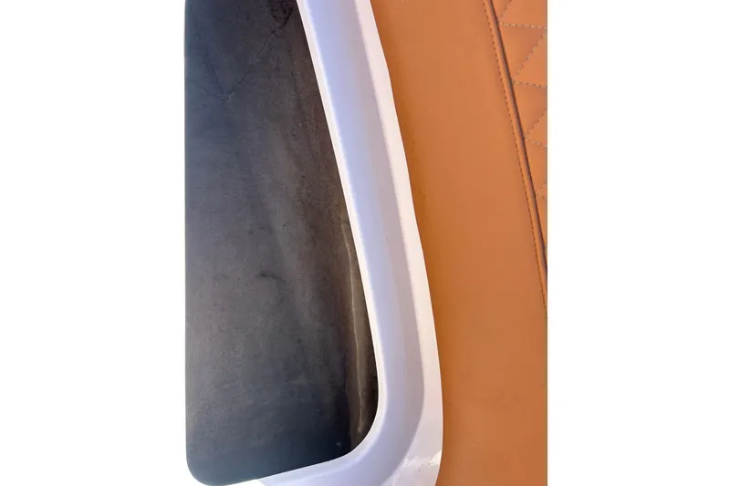 Slide: The Image of Close-up of a 2000 MasterCraft MariStar 210 VRS boat interior, featuring leather and trim details. - 14