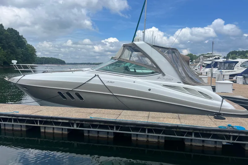 Slide: The Image of 2008 Cruisers Yachts 330 Express docked at a marina under a partly cloudy sky. - 7