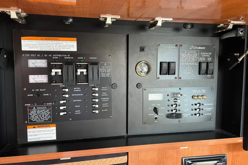 Slide: The Image of Control panel of a 2008 Cruisers Yachts 330 Express, featuring electrical distribution and engine controls. - 30