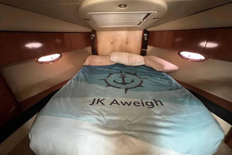 Slide: The Image of Cozy cabin interior of 2008 Cruisers Yachts 330 Express with nautical-themed bedding. - 29