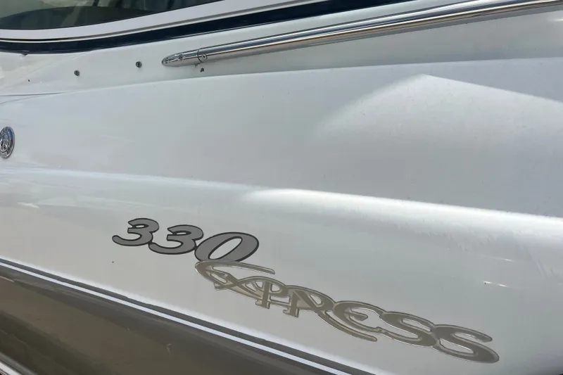 Slide: The Image of Close-up of 2008 Cruisers Yachts 330 Express logo on white hull. - 15