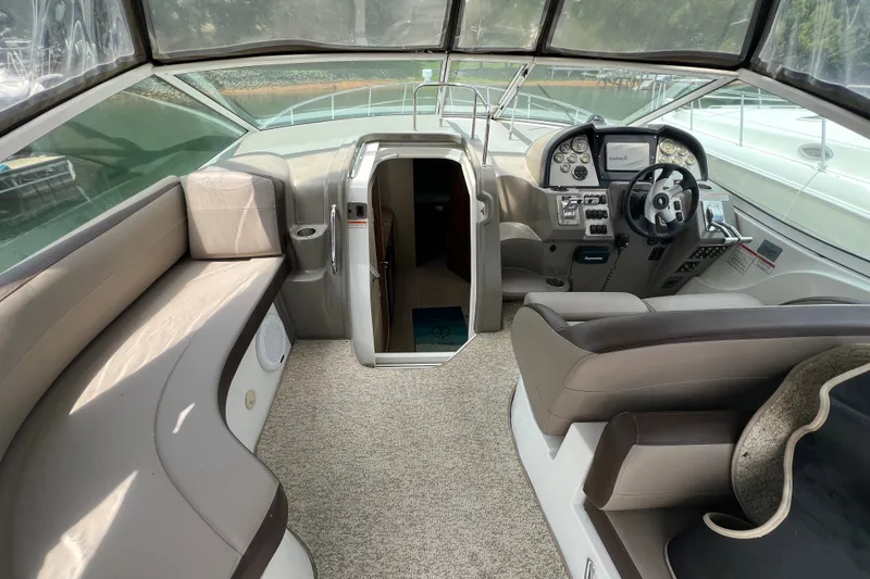 Slide: The Image of 2008 Cruisers Yachts 330 Express cockpit with helm, seating, and cabin entrance. - 23