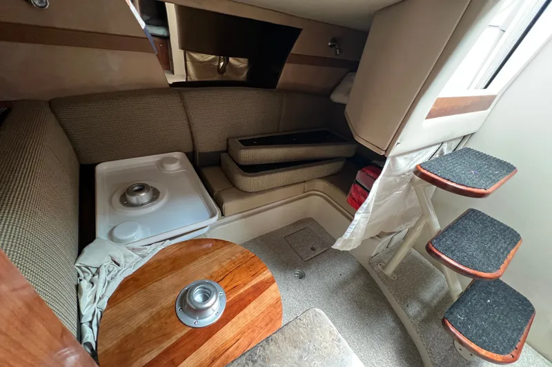 Slide: The Image of 2008 Cruisers Yachts 330 Express cabin interior with seating and compact stairs. - 32