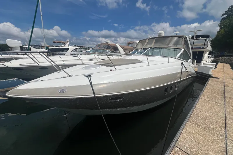 Slide: The Image of 2008 Cruisers Yachts 330 Express docked at marina under blue sky. - 8