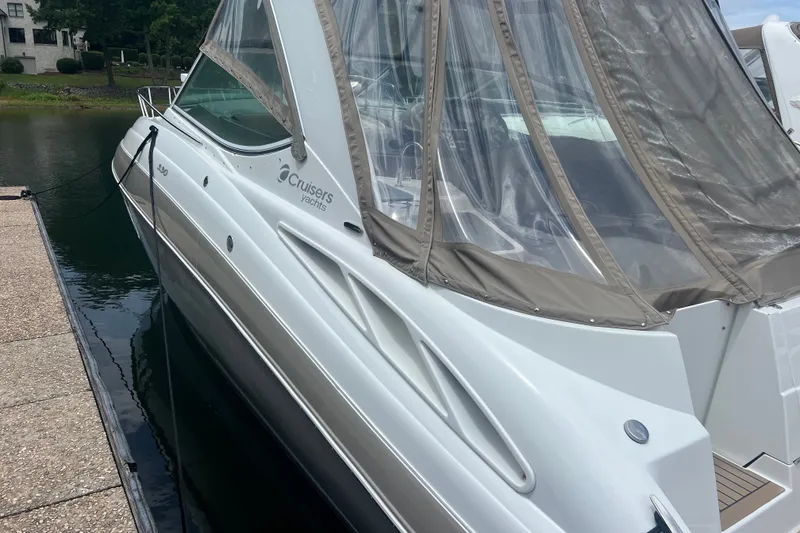 Slide: The Image of 2008 Cruisers Yachts 330 Express docked, featuring sleek design and protective canopy. - 9