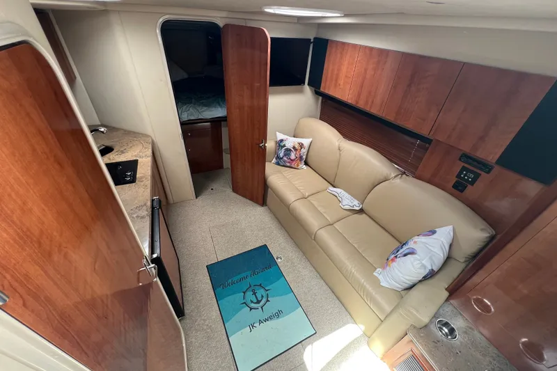 Slide: The Image of Interior of 2008 Cruisers Yachts 330 Express with beige sofa and wooden cabinetry. - 24