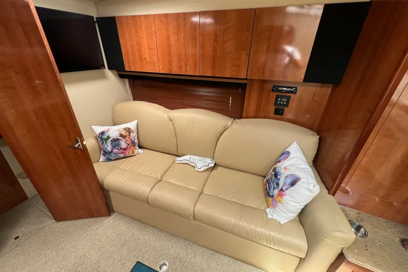 Slide: The Image of Interior of 2008 Cruisers Yachts 330 Express with beige sofa and decorative pillows. - 25