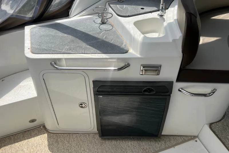 Slide: The Image of 2008 Cruisers Yachts 330 Express interior with sink, countertop, and mini fridge. - 22