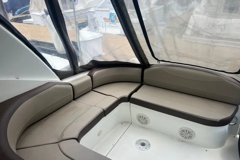 Slide: The Image of 2008 Cruisers Yachts 330 Express interior seating area with beige and brown cushions. - 18