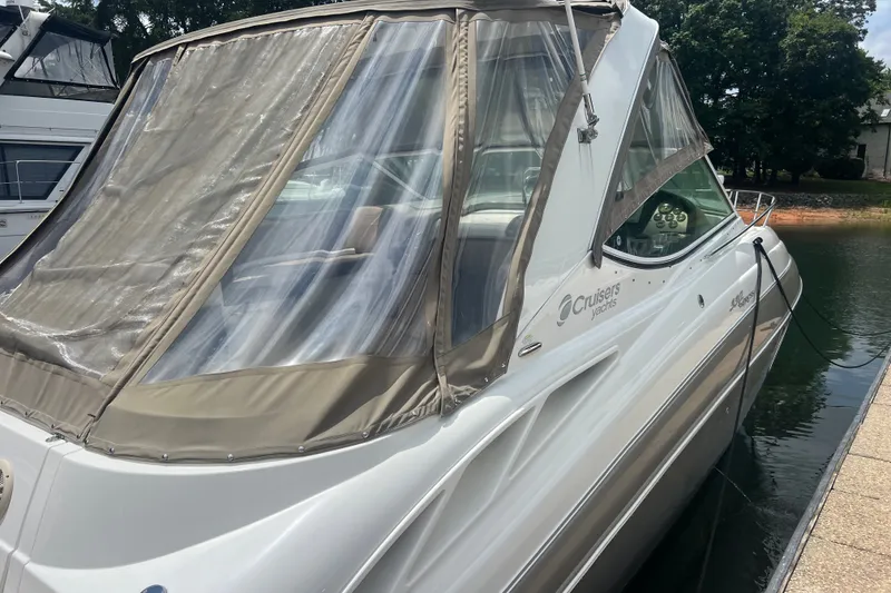Slide: The Image of 2008 Cruisers Yachts 330 Express docked, featuring beige canopy and sleek design. - 11