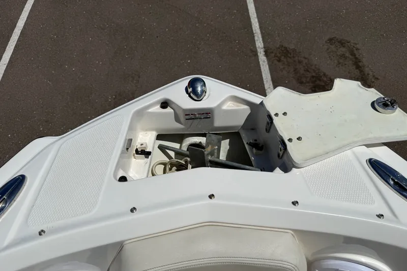 Slide: The Image of 2014 Chaparral 226 SSi boat anchor compartment with open hatch, showing anchor and rope. - 35