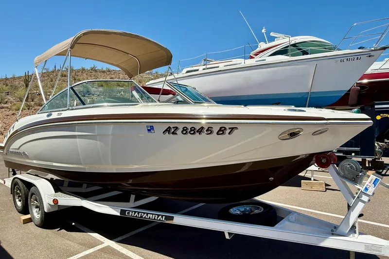 The Image of 2014 Chaparral 226 SSi boat on trailer with canopy, parked outdoors. - 12
