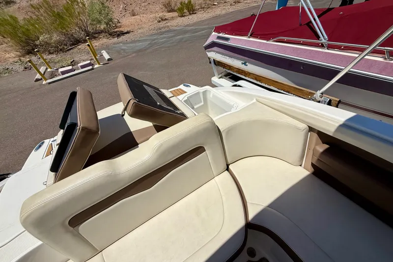 Slide: The Image of 2014 Chaparral 226 SSi boat interior with beige seating and sun deck. - 25