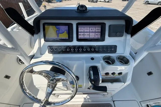Slide: The Image of 2022 Finseeker 230 FS boat dashboard with navigation screens and controls. - 15