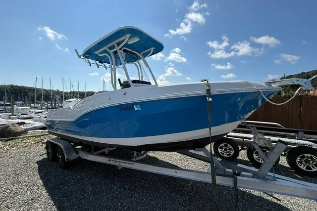 Slide: The Image of 2022 Finseeker 230 FS boat on trailer, blue hull, sunny day, marina background. - 2