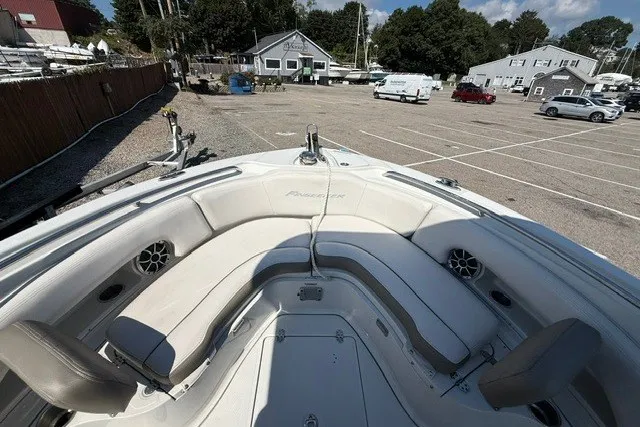 Slide: The Image of 2022 Finseeker 230 FS boat interior with seating and speakers in a parking lot. - 16