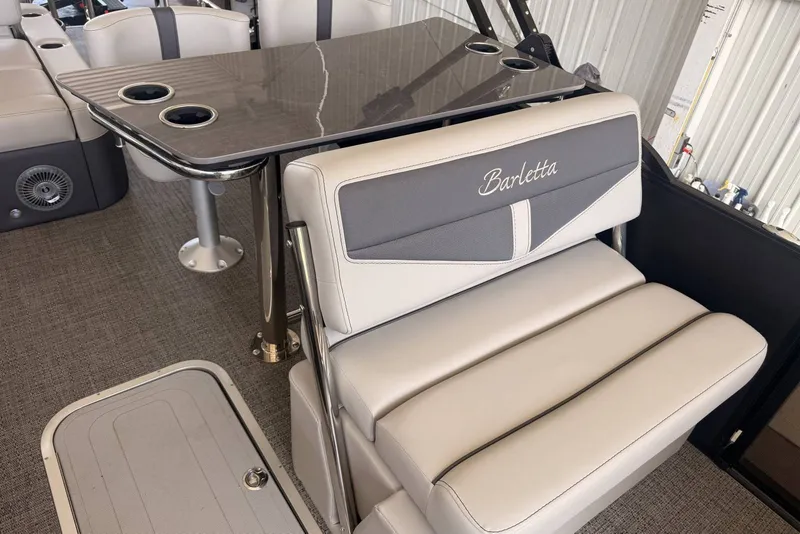 Slide: The Image of 2025 Barletta Cabrio 24UE boat interior with sleek seating and table design. - 16