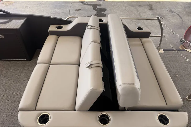 Slide: The Image of 2025 Barletta Cabrio 24UE boat interior with beige seating and cup holders. - 23