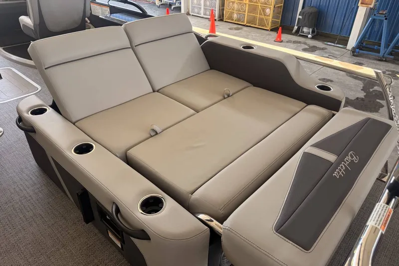Slide: The Image of 2025 Barletta Cabrio 24UE boat interior with luxurious seating and cup holders. - 25