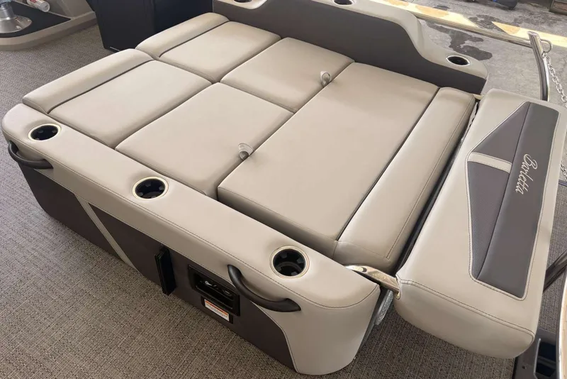 Slide: The Image of 2025 Barletta Cabrio 24UE boat interior with beige cushioned seating and integrated cup holders. - 22