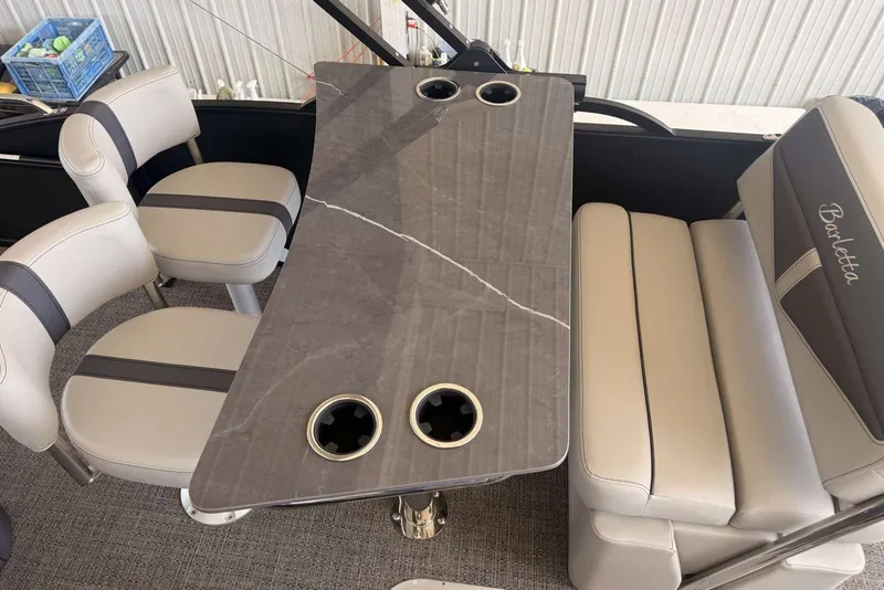 Slide: The Image of 2025 Barletta Cabrio 24UE interior with elegant seating and stylish table design. - 17