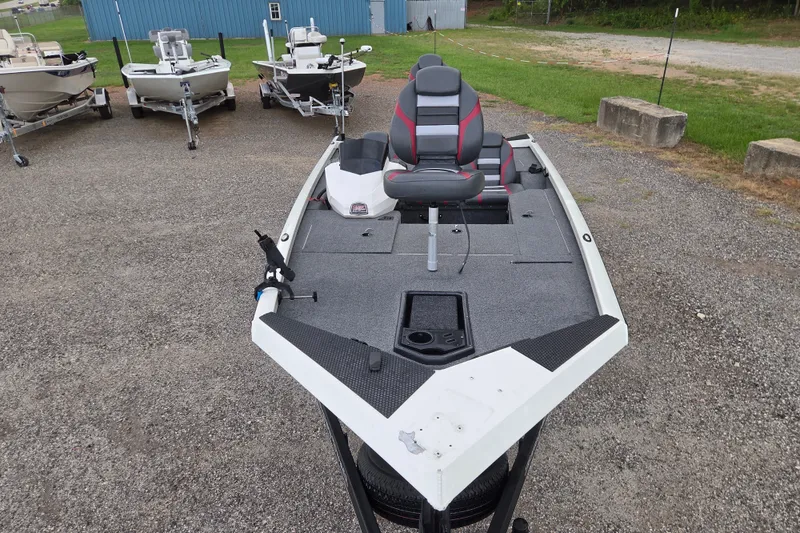 Slide: The Image of 2023 Ranger RT178 fishing boat with seating, parked on gravel lot. - 2