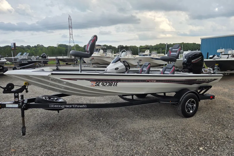 The Image of 2023 Ranger RT178 boat on trailer, parked outdoors under cloudy sky. - 1