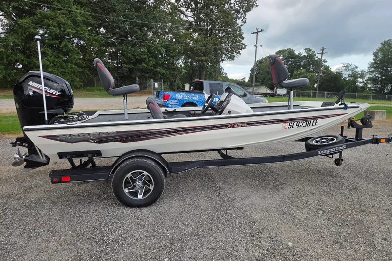 Slide: The Image of 2023 Ranger RT178 boat on trailer with Mercury engine, parked outdoors. - 5