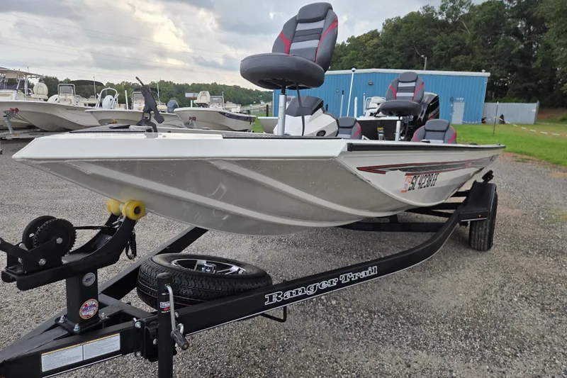 Slide: The Image of 2023 Ranger RT178 boat on trailer, parked outdoors near blue building. - 3