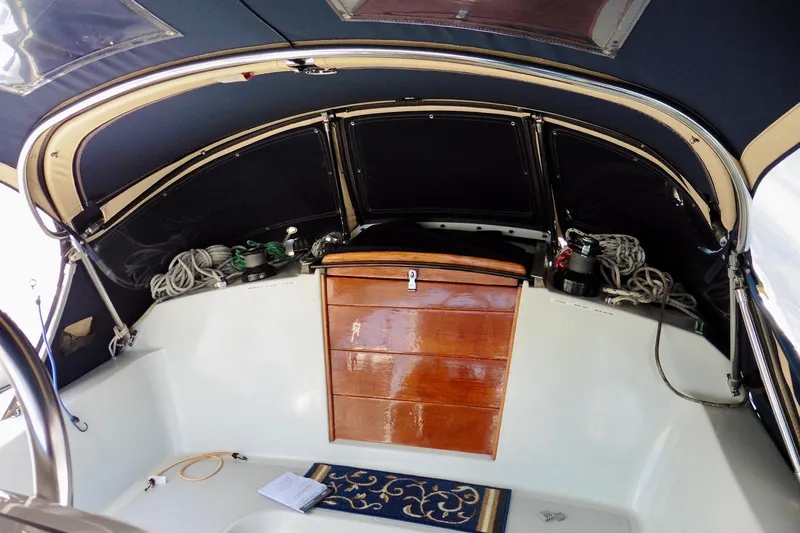 Slide: The Image of Interior of 1986 Ericson 35.3 sailboat cockpit with ropes and wooden storage. - 14