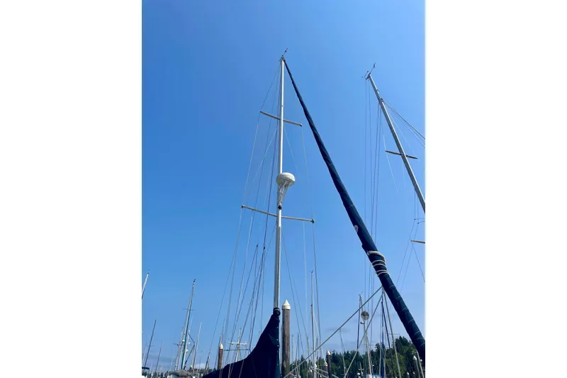 Slide: The Image of Tall masts of a 1986 Ericson 35.3 sailboat against a clear blue sky. - 2