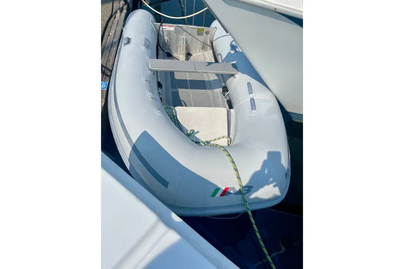 Slide: The Image of Inflatable dinghy docked beside an Ericson 35.3 sailboat, 1986 model. - 12