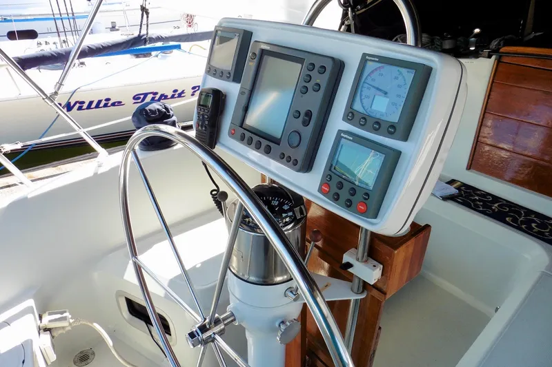 Slide: The Image of Cockpit of 1986 Ericson 35.3 sailboat with navigation instruments and steering wheel. - 16