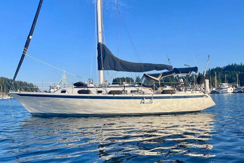 The Image of 1986 Ericson 35.3 sailboat on calm water, clear blue sky background. - 0