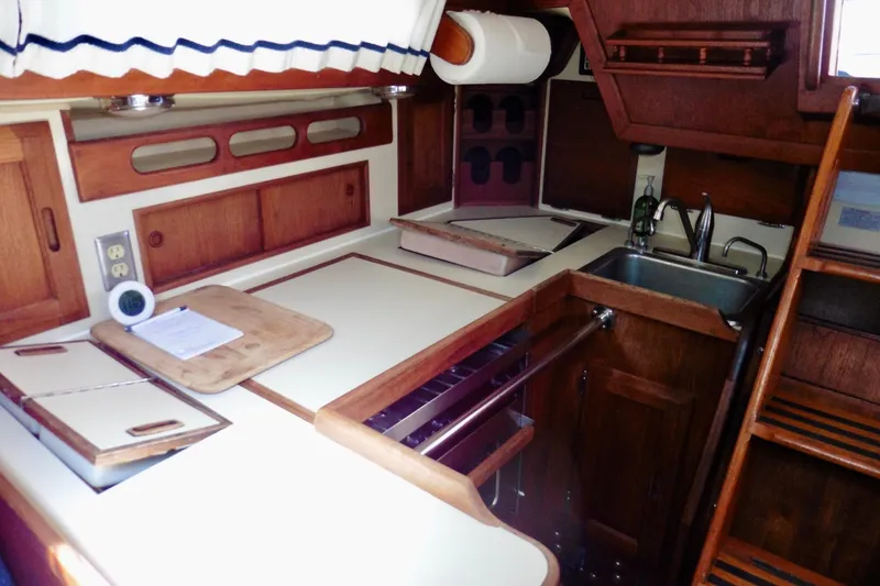 Slide: The Image of Interior of 1986 Ericson 35.3 sailboat galley with wood cabinetry and sink. - 19