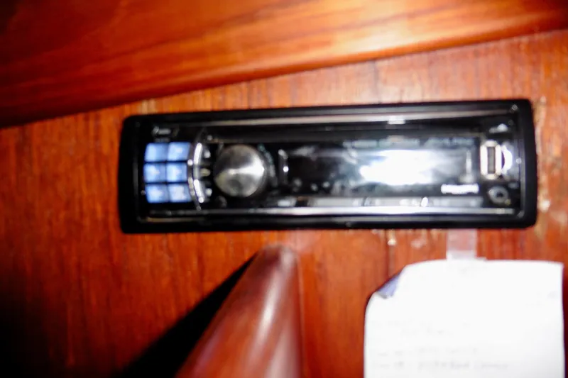 Slide: The Image of Audio system installed on a 1986 Ericson 35.3 sailboat, mounted on wooden paneling. - 33