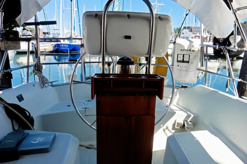 Slide: The Image of Cockpit of 1986 Ericson 35.3 sailboat with steering wheel and marina view. - 18