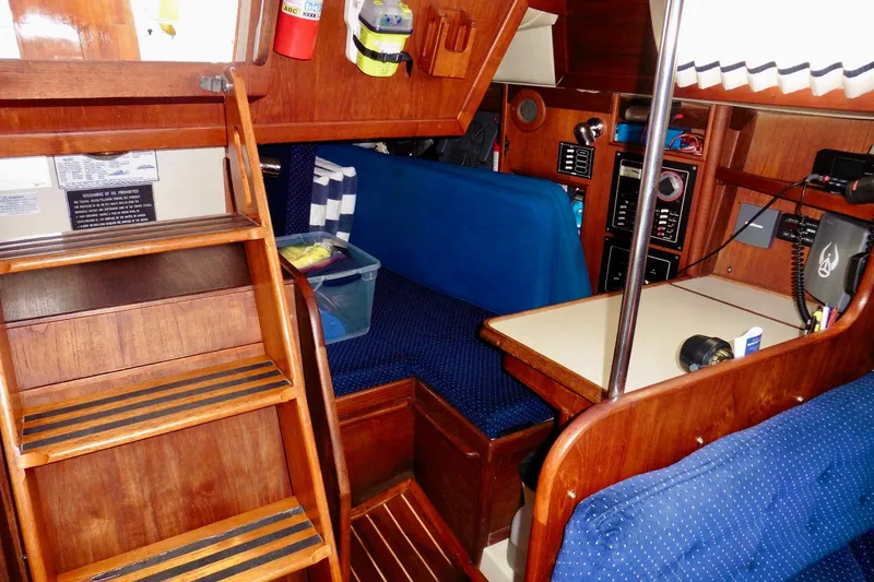 Slide: The Image of Interior of 1986 Ericson 35.3 sailboat with wooden furnishings and blue upholstery. - 20