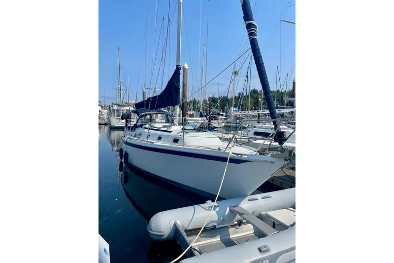 Slide: The Image of 1986 Ericson 35.3 sailboat docked in marina, clear blue sky background. - 1