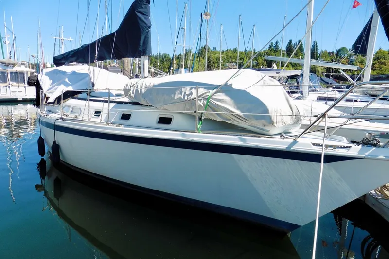 Slide: The Image of 1986 Ericson 35.3 sailboat docked in a marina, covered and ready for sailing. - 9