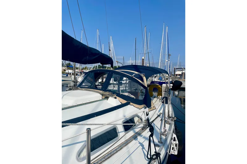 Slide: The Image of 1986 Ericson 35.3 sailboat docked at marina with clear blue sky. - 4