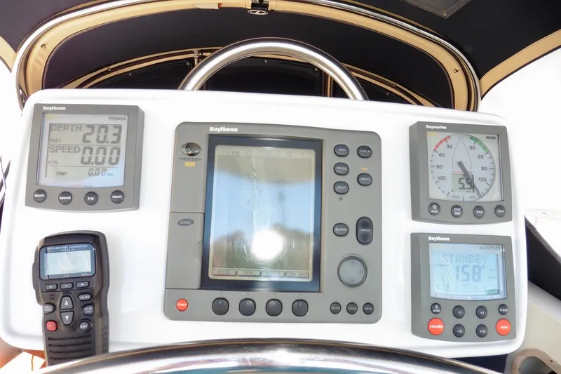 Slide: The Image of Cockpit navigation instruments on a 1986 Ericson 35.3 sailboat, featuring Raytheon displays and controls. - 15