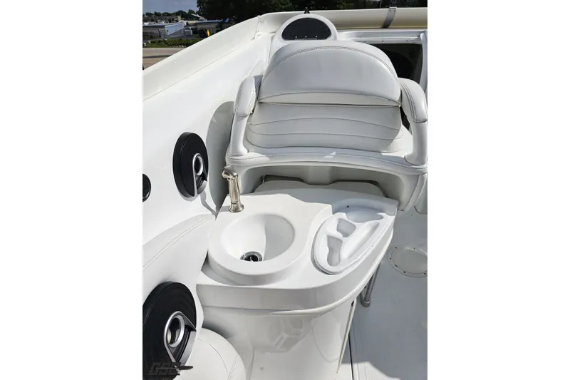 Slide: The Image of 2003 Baja 342 boat interior with white seating, sink, and cup holders. - 43