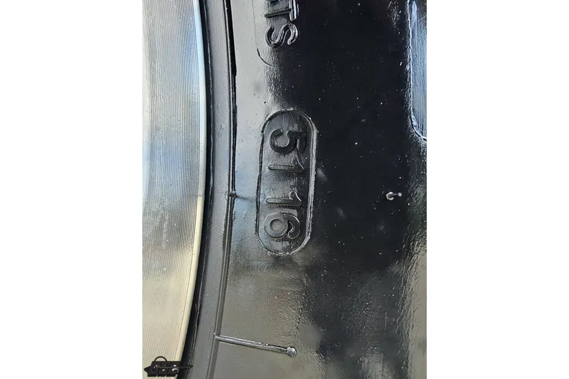 Slide: The Image of Close-up of a black tire with embossed number "5116," Baja 342, 2003 model. - 87