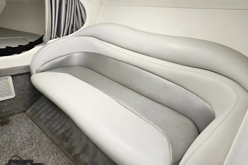 Slide: The Image of 2003 Baja 342 boat interior with plush gray seating and carpeted flooring. - 64