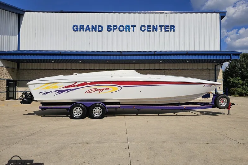 The Image of 2003 Baja 342 boat on trailer at Grand Sport Center, featuring vibrant graphics. - 1