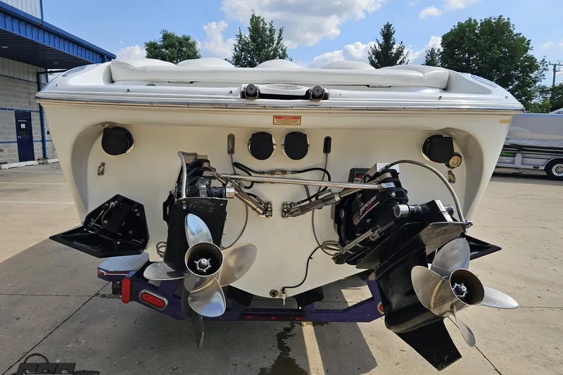 Slide: The Image of Rear view of a 2003 Baja 342 boat with dual propellers and outboard motors. - 28