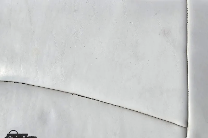 Slide: The Image of Close-up of white leather upholstery from a 2003 Baja 342 boat. - 77
